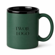 Kubek ceramiczny z czarnym wnętrzem i zielonym wykończeniem.