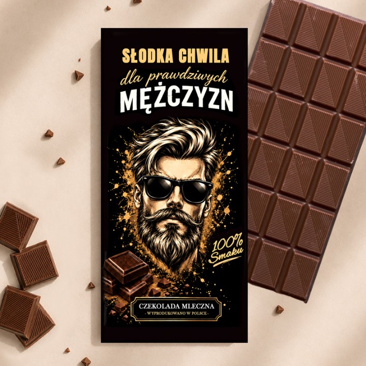 Czekolada mleczna w ozdobnym pudełku jako smaczny prezent świąteczny dla mężczyzny pod choinkę.